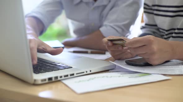 Man and woman paying bills at home