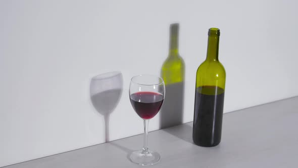 Conceptual Shot, a Bottle of Wine and a Glass on a White Background