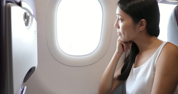 Woman look out of window on airplane