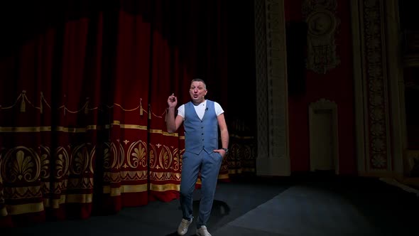 Actor performs on stage. Man on stage during performance in theater