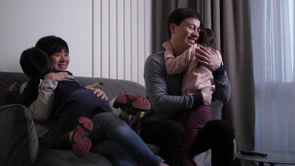 Loving Children Hugging Happy Parents Indoors