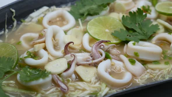 Close-Up Footage of Hot and Sour Squid in Chilli, Garlic and Lime Soup