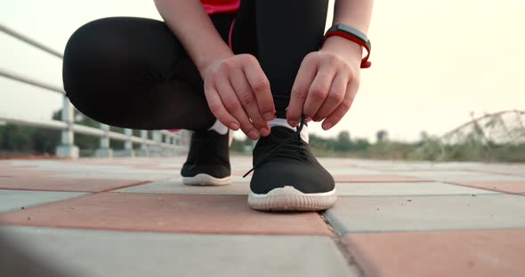 Woman hands tying sport shoes before running outdoor