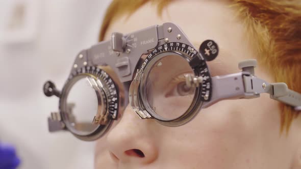 Close Up of Little Boy Having Eye Vision Test with Trial Frame