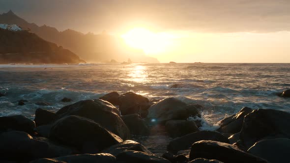 Ocean Waves Crash on Rocks and Spray in Beautiful Sunset Light at Benijo Beach in Tenerife, Canary