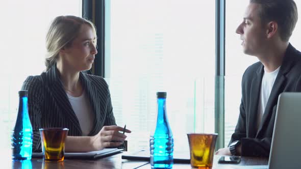 Beautiful young businesswoman professional talking to businessman with partnership together.