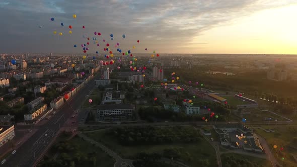 Colourful Balloons Flying in Sunrise Lights in the City Aerial Footage