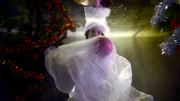 Snow Maiden Plays with Red Ball Underwater Slow Motion