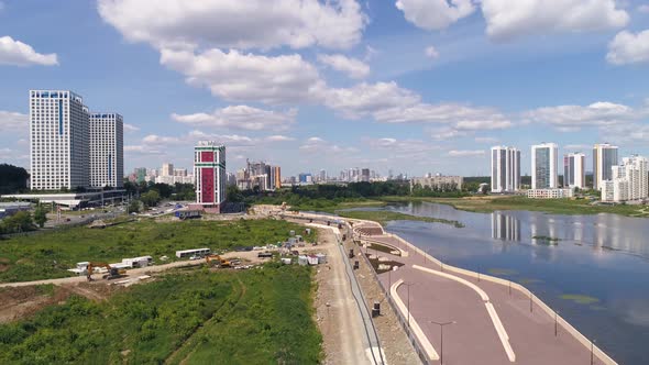 Aerial view of construction of an embankment in the city on the river bank 02