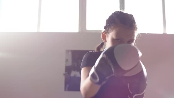 Portrait of a Teen Girl Boxer Working Out the Bumps in the Ring. Slow Motion