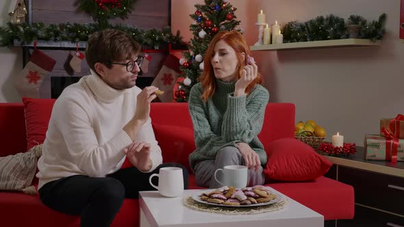 Two friends having tea and gingerbread biscuit in a romantic atmosphere.