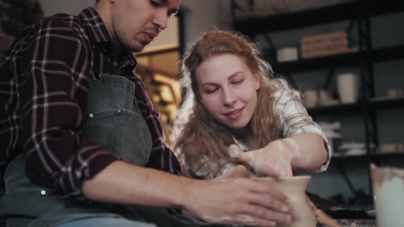 Potter Masterclass Man and Woman are Working with Pottery Wheel Making Pots During Master Class for