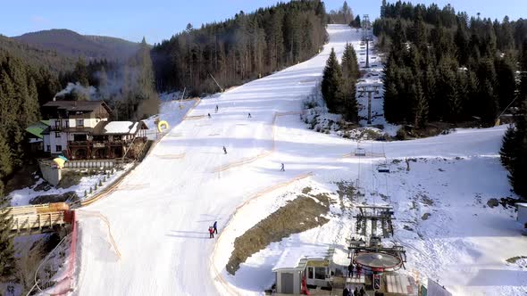 Aerial view of the ski resort with snowy mountain slopes and winter trees. Stock footage