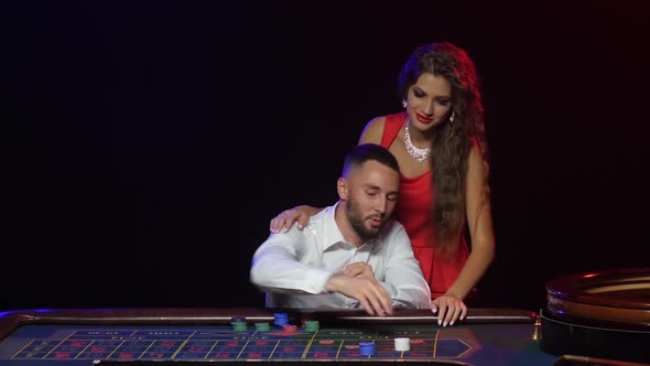 Croupier Pushes a Young Couple To Win at Roulette Chips