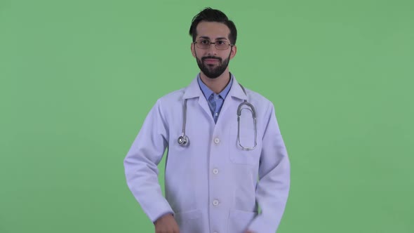 Happy Young Bearded Persian Man Doctor Giving Thumbs Up and Looking Excited