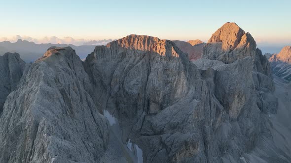 Dolomites mountains peaks with a hiking path on a summer sunrise