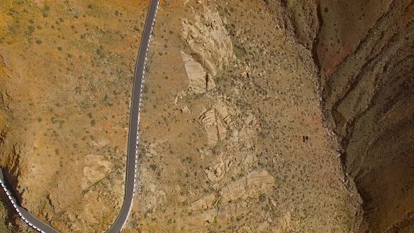 Aerial view of the winding mountain road between two villages of Fuerteventura.