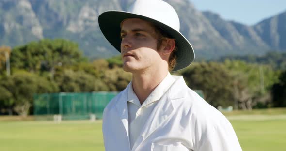 Cricket umpire signaling a no ball during match