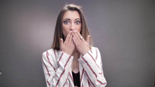 Portrait of beautiful girl surprised and shocked on grey background