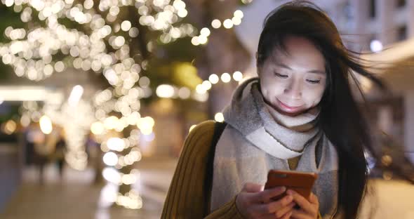 Asian woman use of smart phone at night