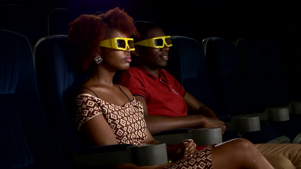 Happy African American Couple Watching Movie 3D In Theatre. Close Up