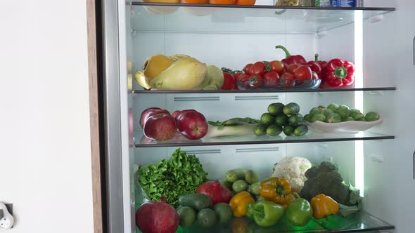 Woman Taking Raw Food From Refrigerator
