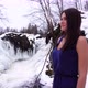 A beautiful girl in a blue dress at a frozen waterfall looks into the distance 4K - VideoHive Item for Sale