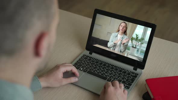 Back View of Businessman Talk with Woman Business Partner Using Video Call on Laptop Discuss Work