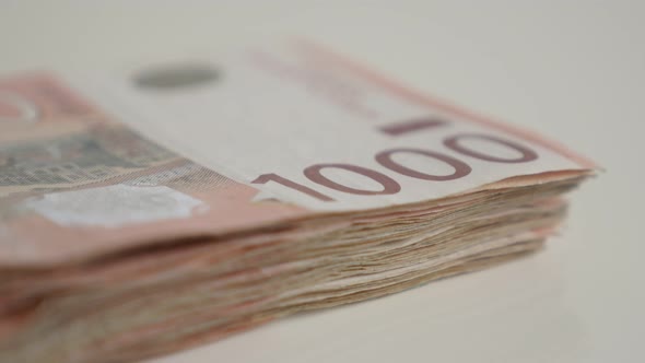 Tilting over denominations of 1000 dinars shallow DOF 4K 2160p 30fps UltraHD  footage - Serbian bank