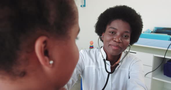 Happy Young Woman Doctor Wearing White Medical Coat And Stethoscope Looking At