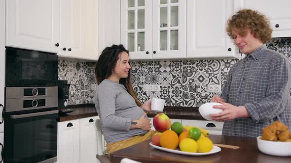 Man which Preparing Delicious Breakfast for His Trendy Pretty Pregnant Wife 