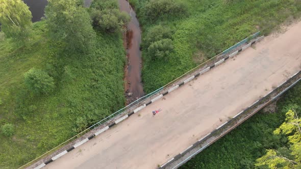 Father and Daughter Playing Having Fun on Old Soviet Road Bridge Aerial