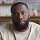 Closeup Portrait of Handsome Young African American Bearded Man Sitting on Sofa at Home in Living - VideoHive Item for Sale