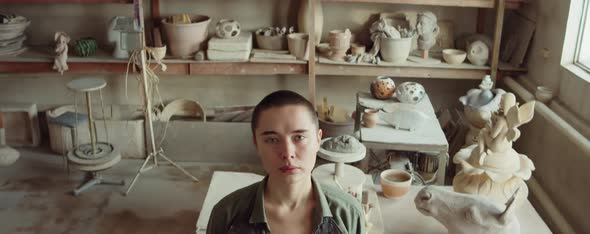 Portrait of Young Woman at Work in Pottery Studio