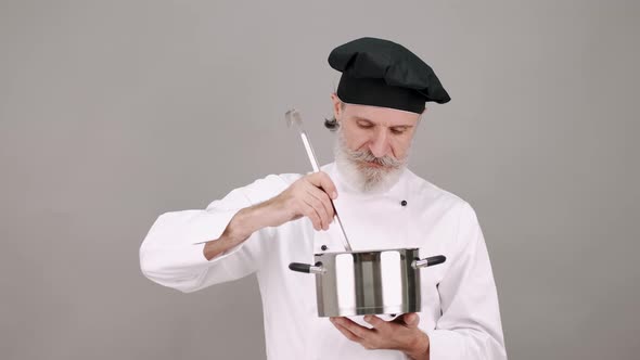 Professional Chef with a Pot on Grey Copy Space