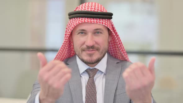 Portrait of Middle Aged Arab Businessman Inviting with Hand Gesture