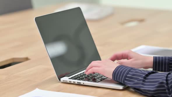 Side View of Businesswoman Typing on Laptop