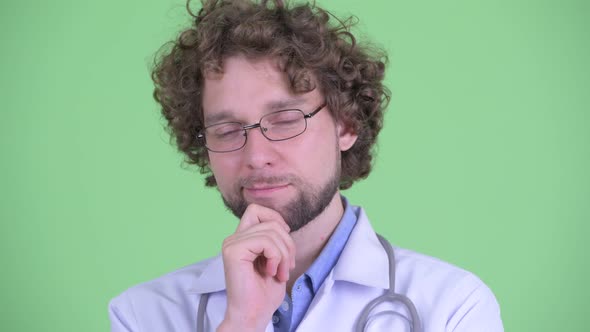 Face of Stressed Young Bearded Man Doctor Thinking