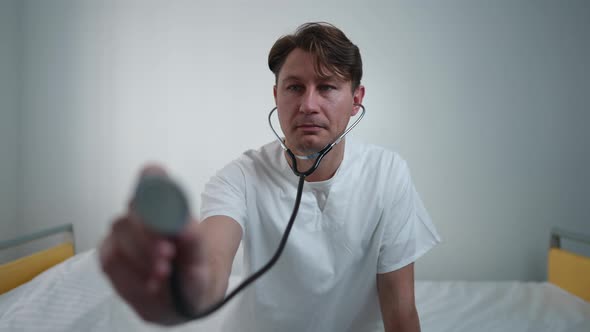 Patient's POV of Focused Professional Doctor Listening Auscultation with Stethoscope Thinking