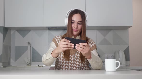 Amazed Woman Playing Smartphone Shocked Saying WOW