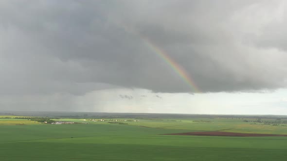 Top View of a Sown Field After Rain with a Rainbow in Belarus