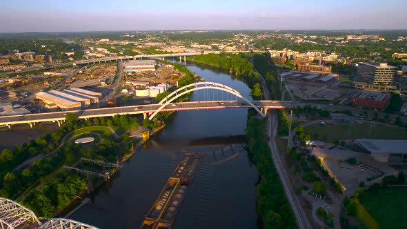 Aerial view of a transport ship on the Crumbland river, golden hour in Nashville, USA - Descending,