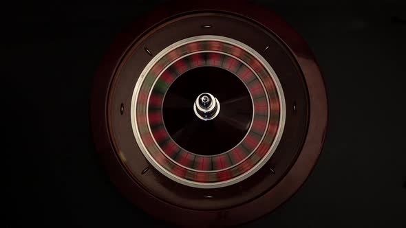 Person Spinning Roulette on Black