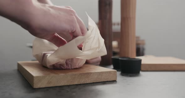 Slow Motion Man Unwrap New York Steak on Countertop