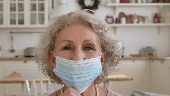 Retired Woman Lowers Protective Mask and Smiles Gently