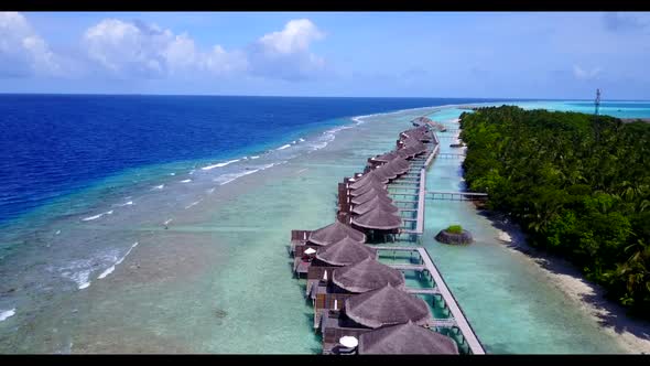 Aerial texture of tranquil seashore beach voyage by shallow lagoon with white sandy background of a 