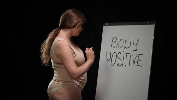 Confident Plus Size Caucasian Brunette Woman Standing at Whiteboard Writing Body Positive Smiling