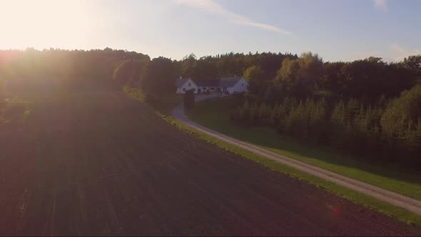 Aerial Video Approaching A Farm During Sunset At Low Height