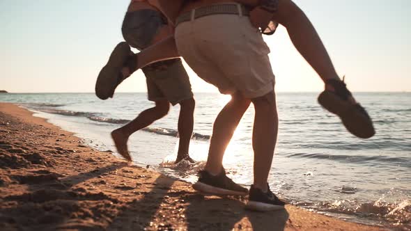 Friends Smiling Laughing Speaking Walking at Seaside at Sunrise