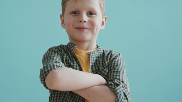 Boy Posing Against Blue Background